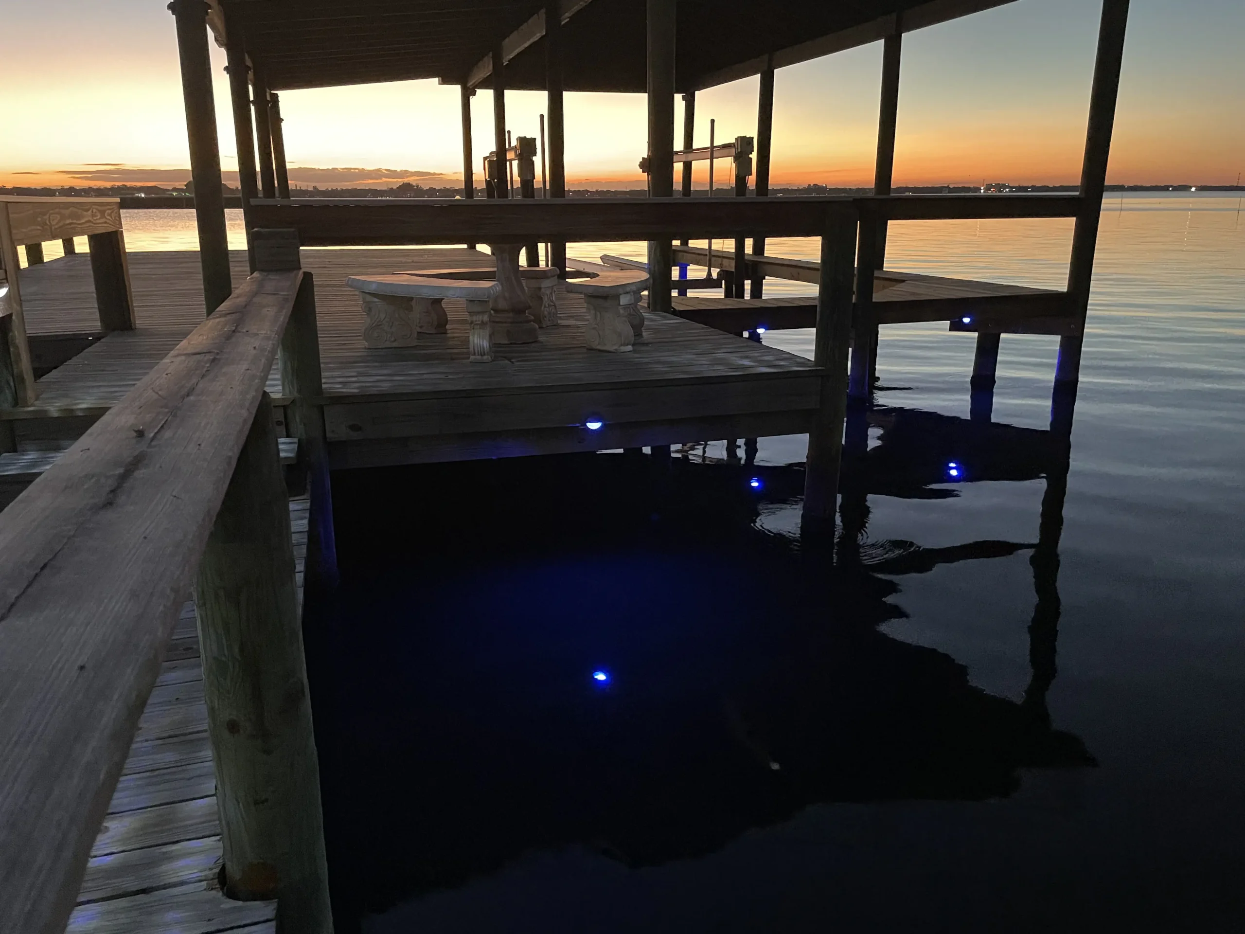 Illuminated boat dock with underwater LED lights at sunset in Brevard County FL